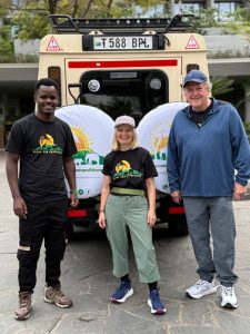 Native Son Expeditions guide leading guests wearing company t-shirts during a walking safari in Tanzania